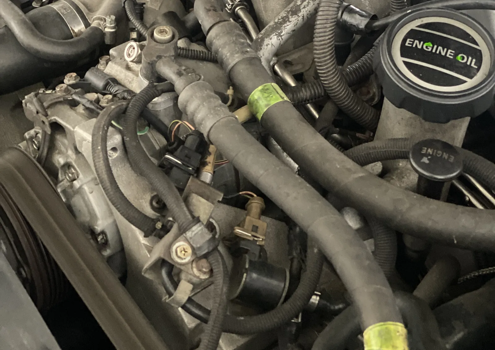 Engine oil cap and hoses in the V8 engine bay of a Bentley Arnage