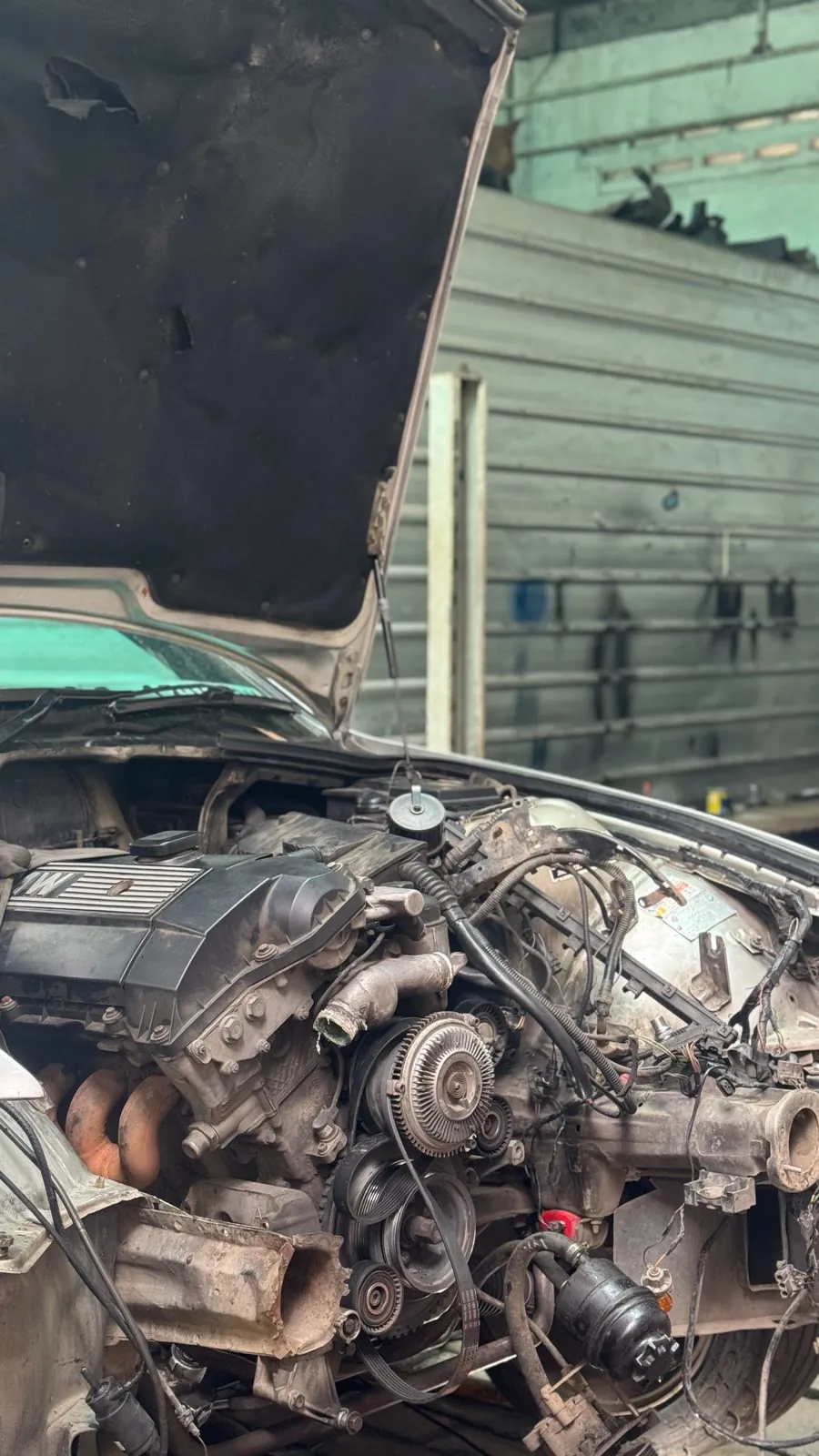 Silver E36 with bonnet raised and engine bay stripped to the engine and ancillaries