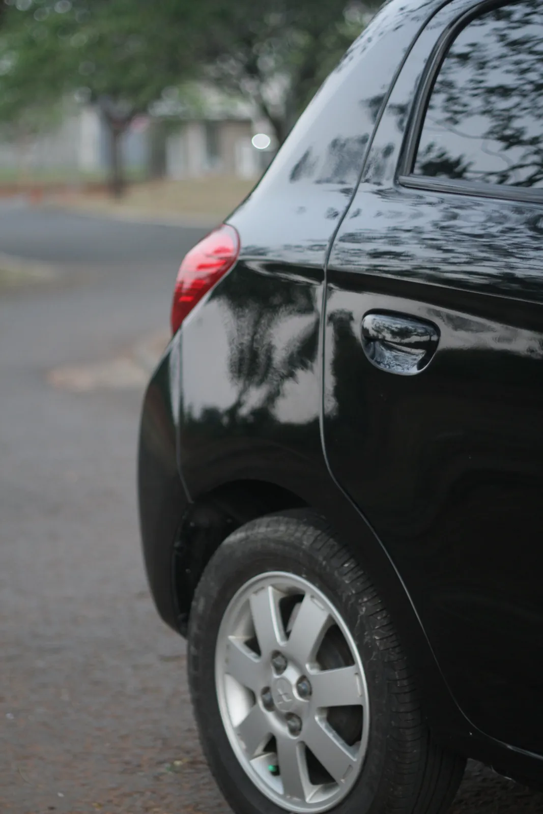 Rear quarter of a glossy black Mitsubishi Mirage